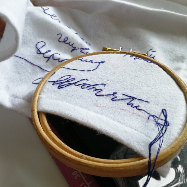 personalised handkerchiefs, made from white organic cotton, hand embroidered with custom handwritten messages