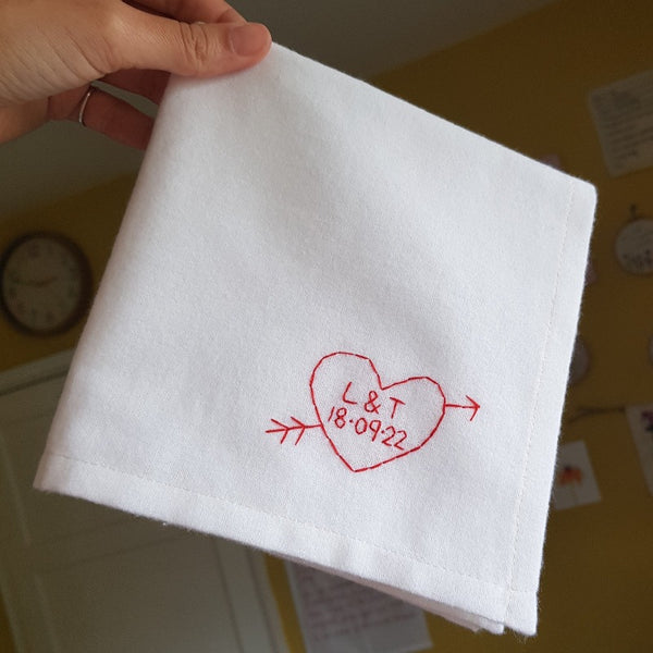 personalised handkerchief gift, made from white organic cotton, hand embroidered with custom heart, initials of couple and wedding or anniversary date