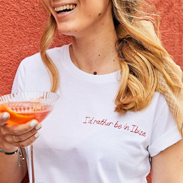 organic cotton white slogan t-shirt, embroidered with 'i'd rather be in ibiza' in red thread. 