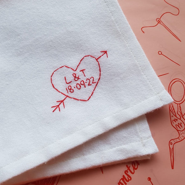 personalised handkerchief gift, made from white organic cotton, hand embroidered with custom heart, initials of couple and wedding or anniversary date