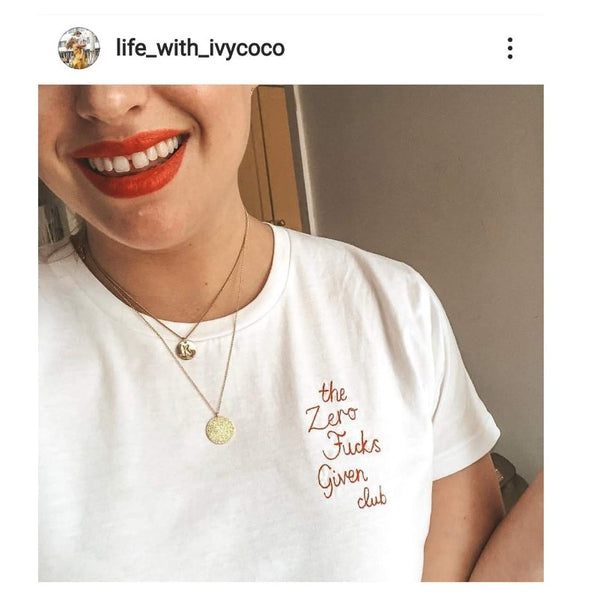 organic cotton white slogan t-shirt, embroidered with 'the zero fucks given club' in red thread. funny gift for new mum