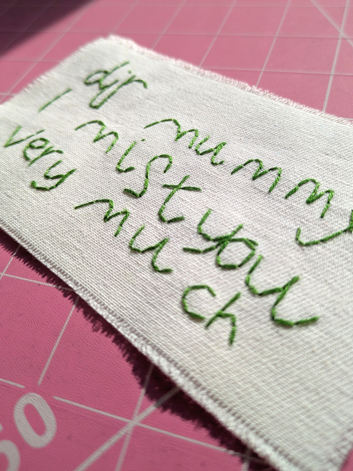 child's handwritten message hand embroidered on cotton with a raw edge made to be framed