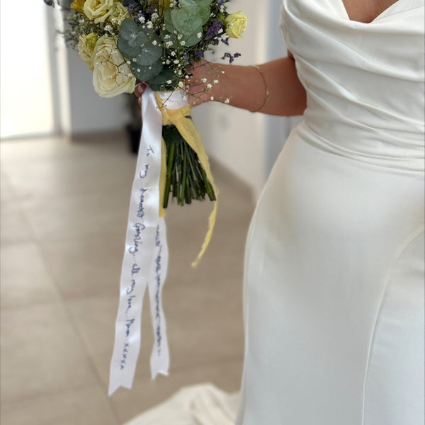 handwritten message hand embroidered on wedding bouquet ribbon