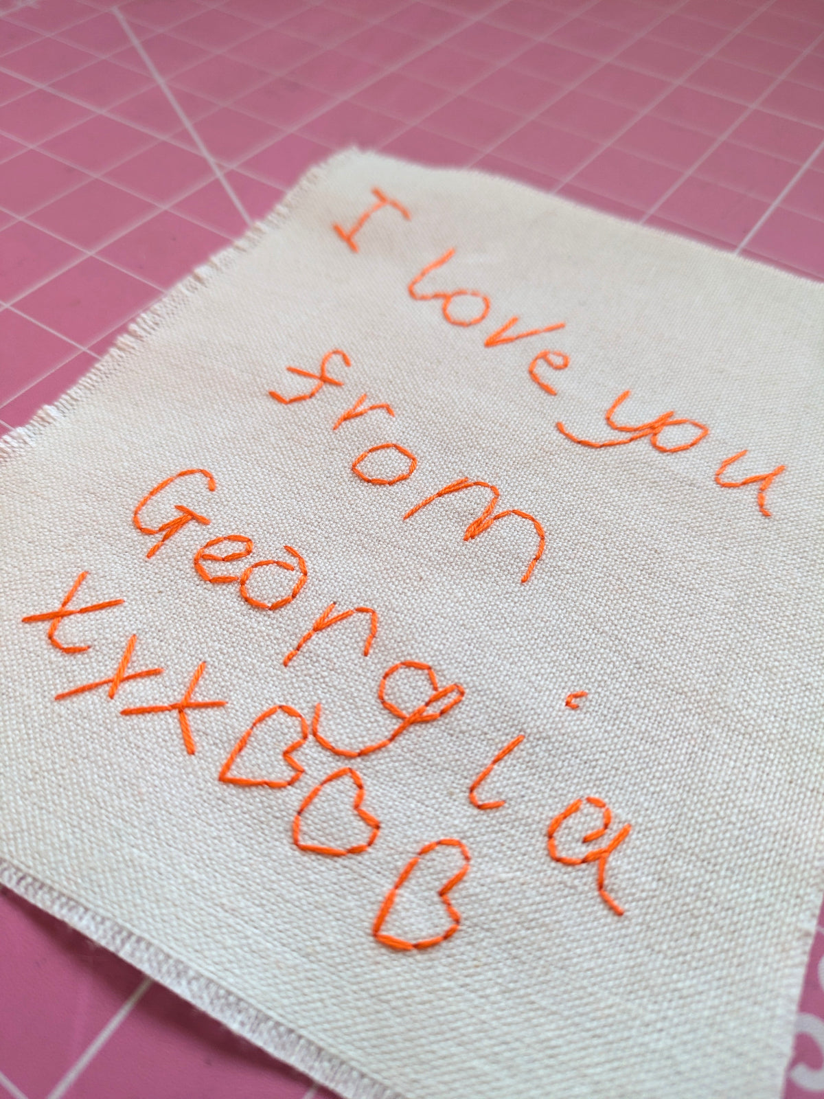 personalised child's handwriting hand embroidered in orange thread