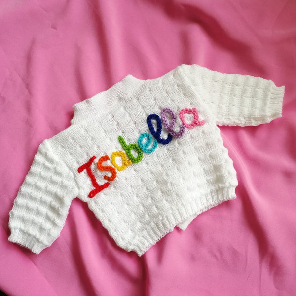 personalised baby name cardigan, embroidered with new baby girl's name in rainbow knit
