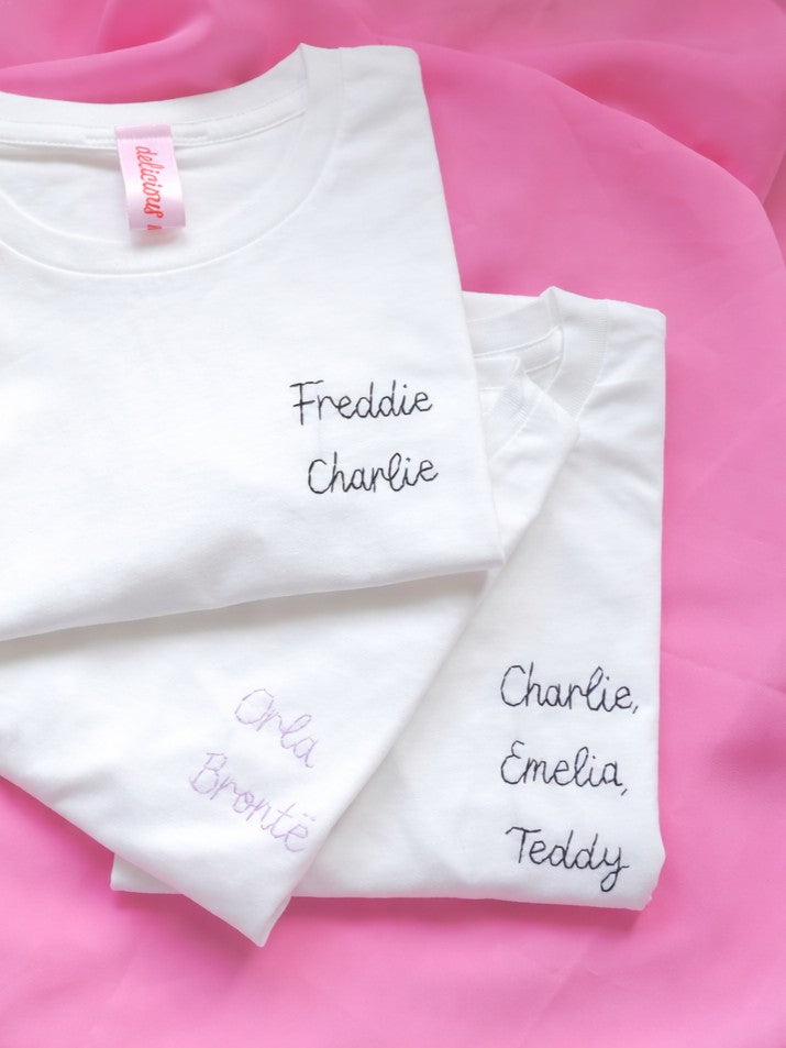 pile of tshirts embroidered with kids names as mothers day gift