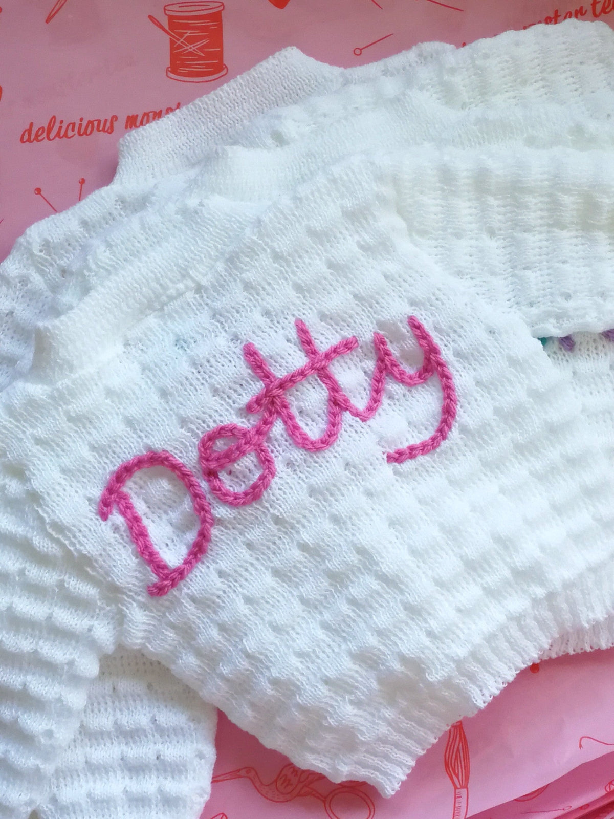 Personalised baby cardigan with pink hand embroidered name detail