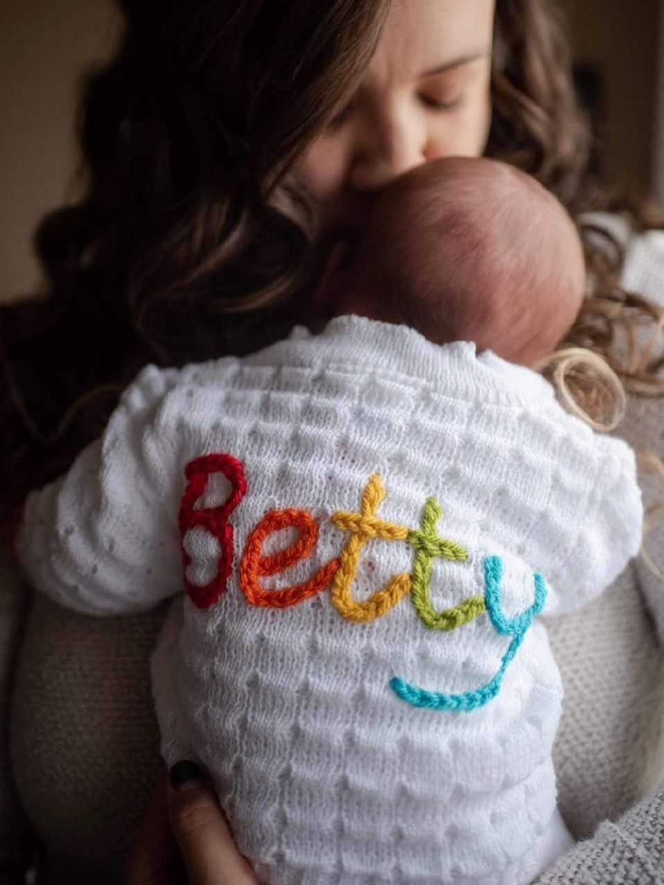rainbow baby personalised cardigan on newborn