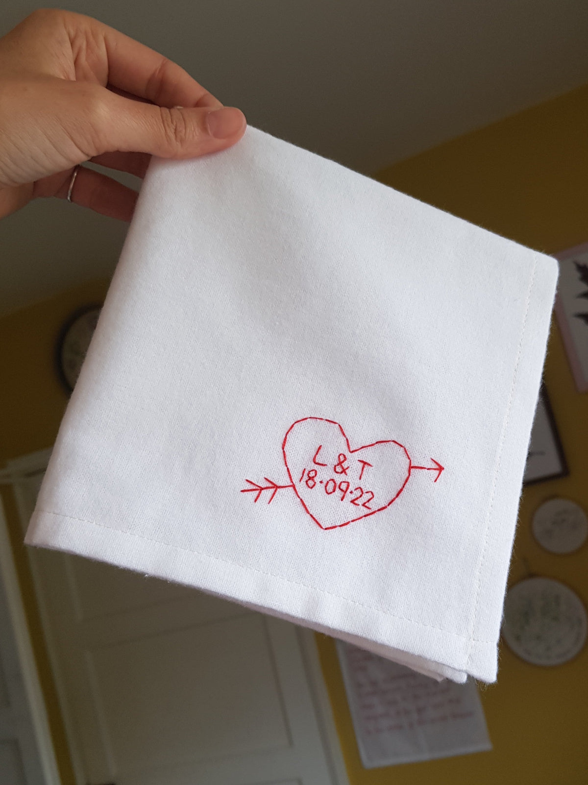 white handkerchief with heart embroidered on it with initials and date, as second anniversary gift