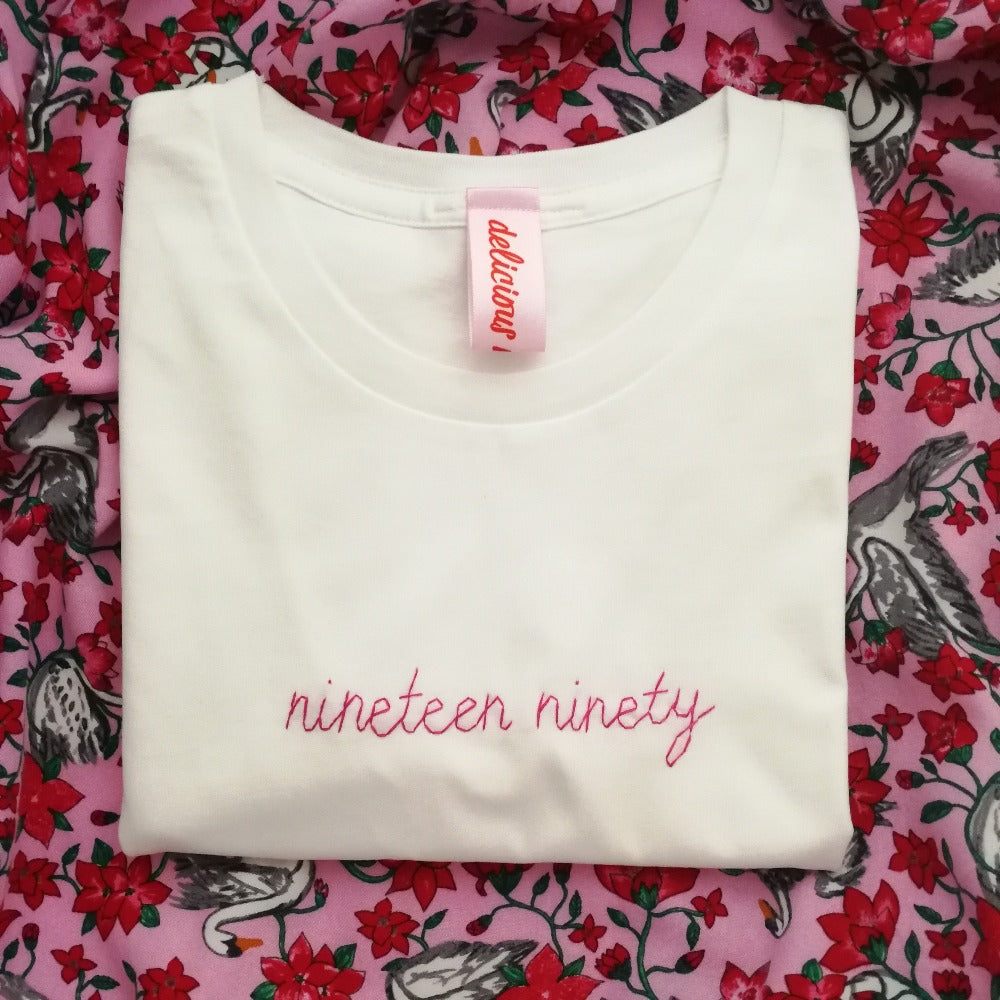 organic cotton white slogan t-shirt, embroidered with 'nineteen ninety' in pink thread. personalised birth year birthday gift for her