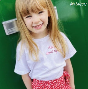 personalised kids t-shirt, made from white organic cotton, and hand embroidered with custom slogan, as a gift for child