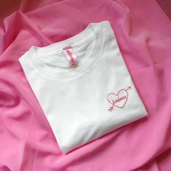 hand embroidered t-shirt, made from white organic cotton, and hand embroidered with a personalised love heart 'kindness'