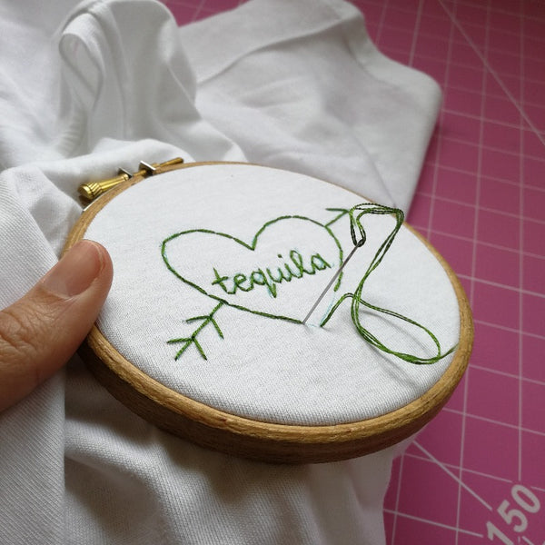 hand embroidered t-shirt, made from white organic cotton, and hand embroidered with a personalised love heart 'tequila'