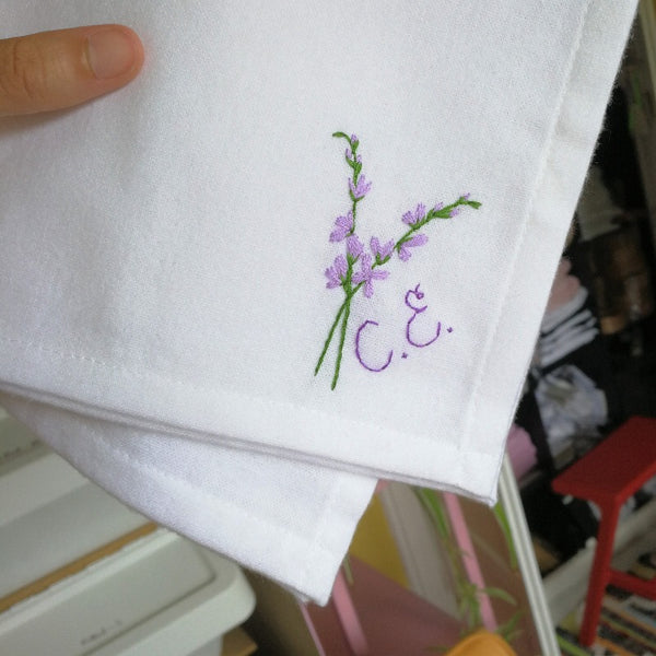 birth flower personalised handkerchief, made from white organic cotton, hand embroidered with larkspur and initials or monogram, as wedding gift for bride