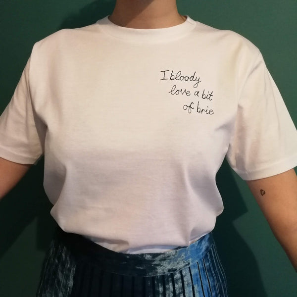 organic cotton white slogan t-shirt, embroidered with 'i bloody love a bit of brie' in black thread. funny christmas gift for dad or boyfriend who loves cheese