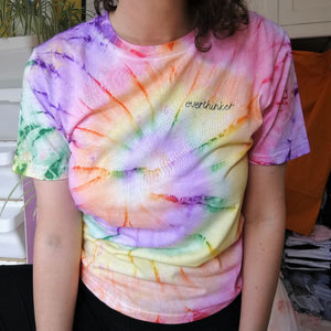 unisex rainbow tie-dye personalised t-shirt, made from organic cotton, and hand embroidered with custom slogan 'overthinker' in black thread, as funny gift for anxious millennial