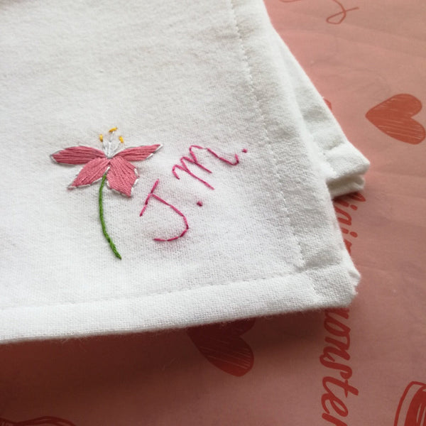 personalised birth flower handkerchief, made from white organic cotton, hand embroidered with pink stargazer lily and initials or monogram, as christmas gift for grandma