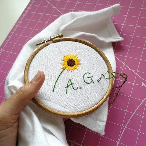 personalised handkerchief, made from white organic cotton, hand embroidered with sunflower and initials or monogram, as birthday gift for mum
