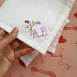 personalised handkerchief, made from white organic cotton, hand embroidered with sweet peas and initials or monogram, as wedding gift for bride