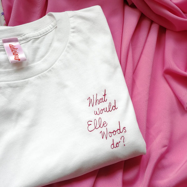 organic cotton white slogan tshirt, embroidered with what would elle woods do in pink thread. funny gift for law student graduation or legally blonde fan